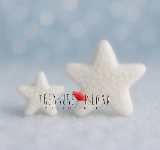 Two white hand-felted stars in small and large sizes for winter newborn and sitter photography setups