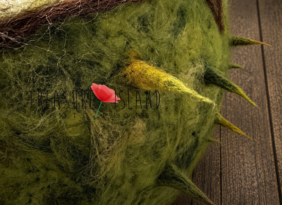Close-up of hand-felted wool texture and chestnut spikes on newborn photography bowl