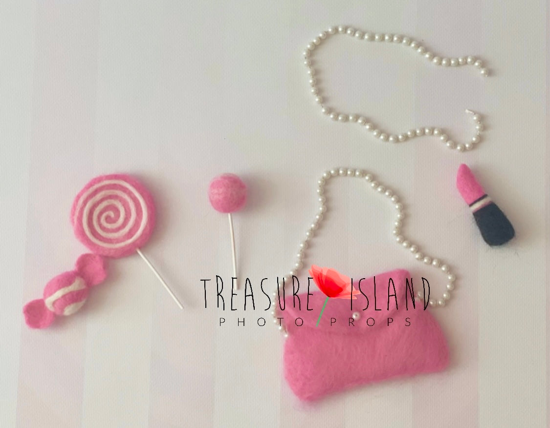 Handmade doll-inspired miniature accessories in pink for creative newborn photography setups