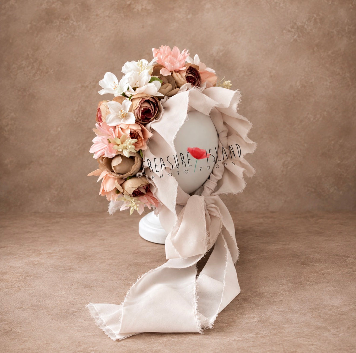 Side view of handmade floral photography bonnet with layered artificial flowers and flowing fabric ties