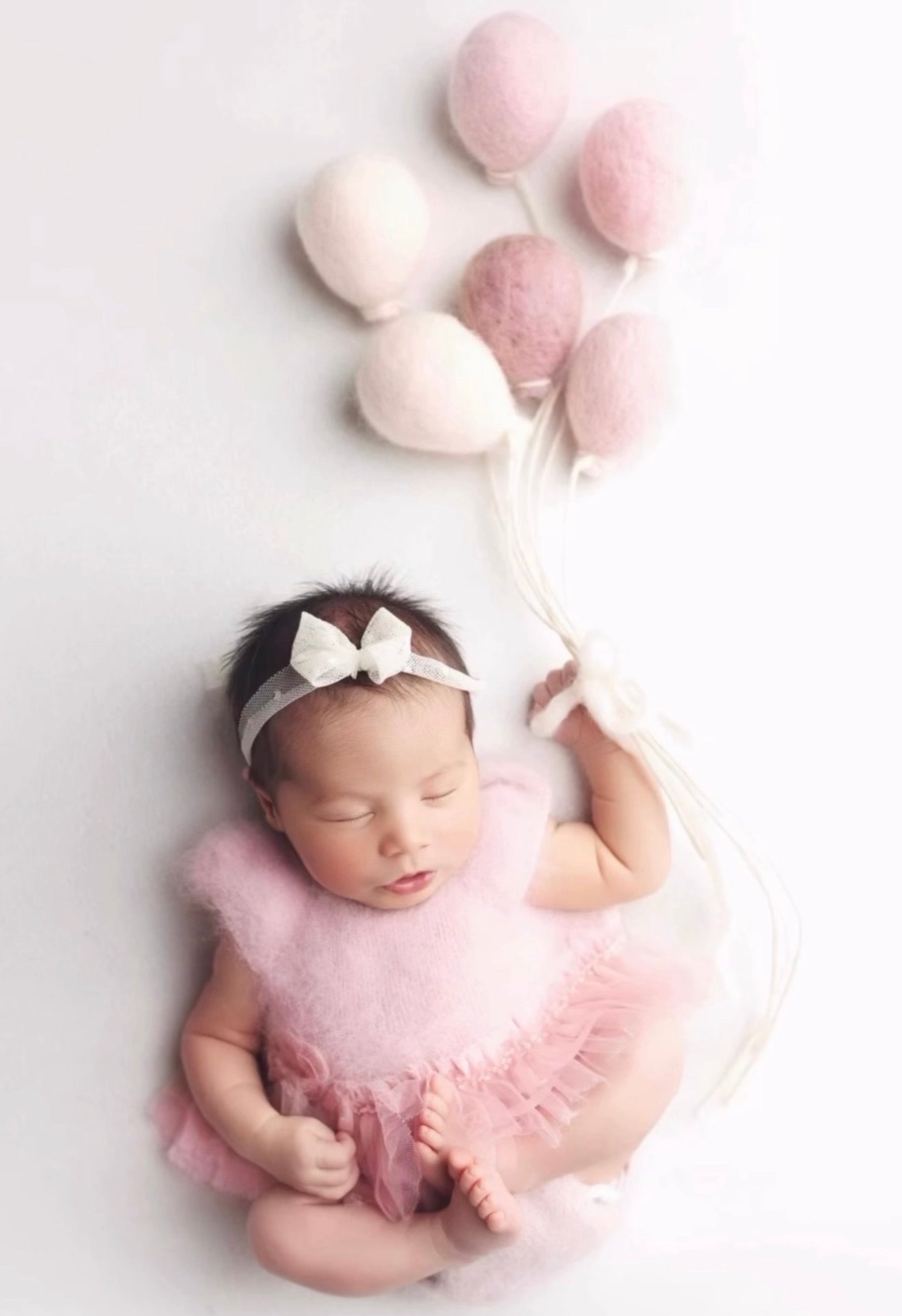 Handmade felted wool balloons used as a newborn photography prop