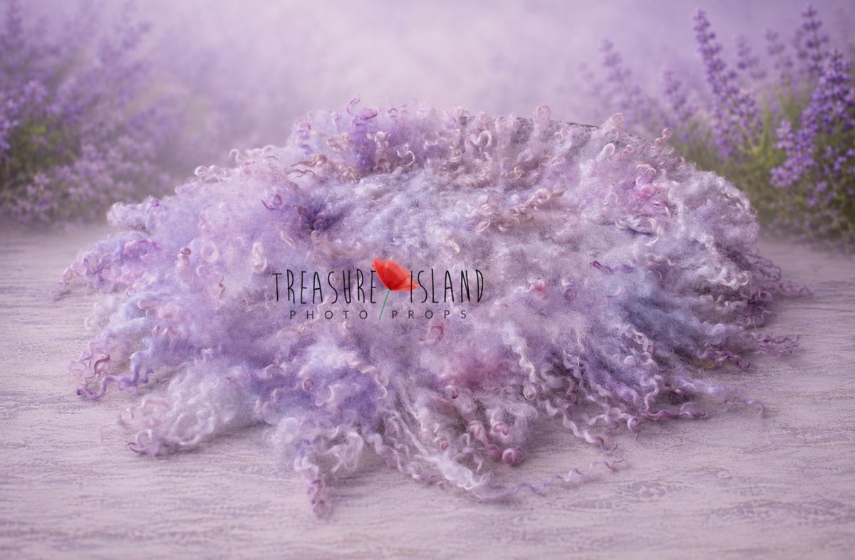 Hand-felted Lilac and Lavender curly wool blanket with natural sheep curls in soft pastel shades, displayed in a lavender-inspired studio setting