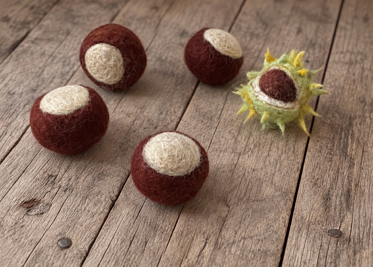 Handmade mini chestnut photography props with four felted chestnuts and one green chestnut shell