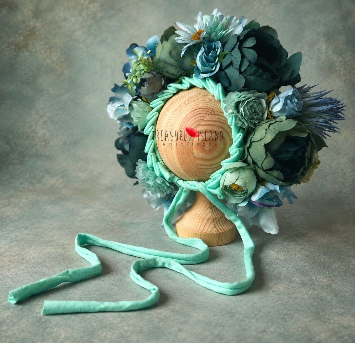 Handmade petrol and aqua floral bonnet showing layered botanical details and mint ties