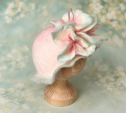 Side view of handmade pink and pale sage felted flower petal hat with delicate wool stamens for newborn photography
