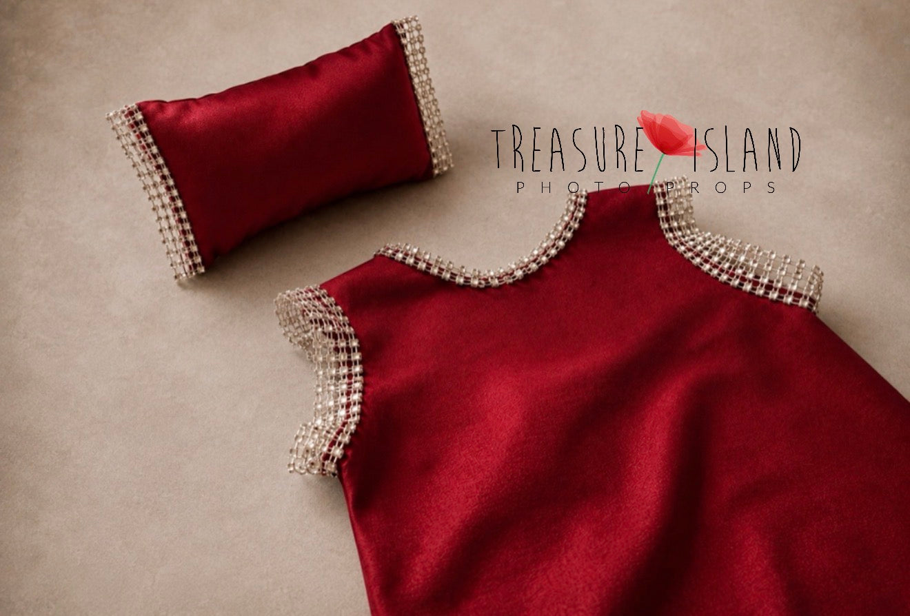 Close-up of handmade red baby photography shorts with sparkling crystal trim and matching pillow