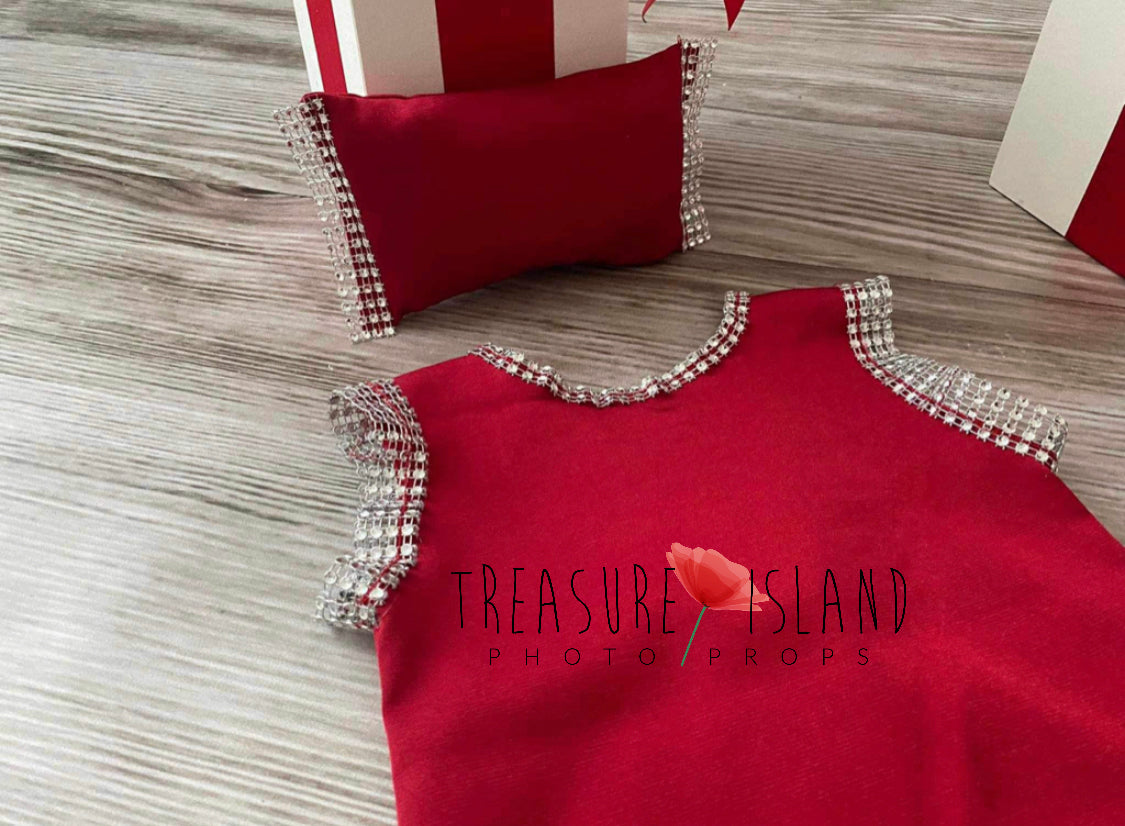 Detailed view of red baby photography shorts with sparkling trim and matching decorative pillow