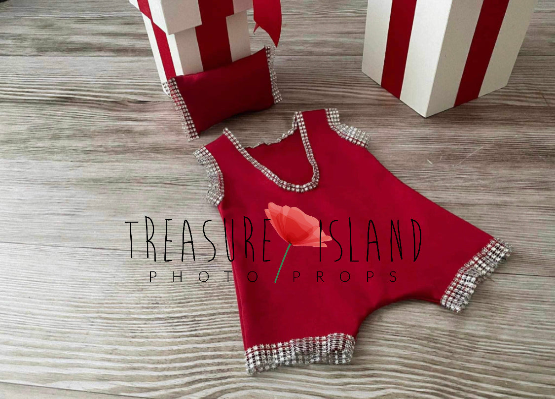 Red newborn photography shorts with decorative crystal trim and coordinating miniature pillow
