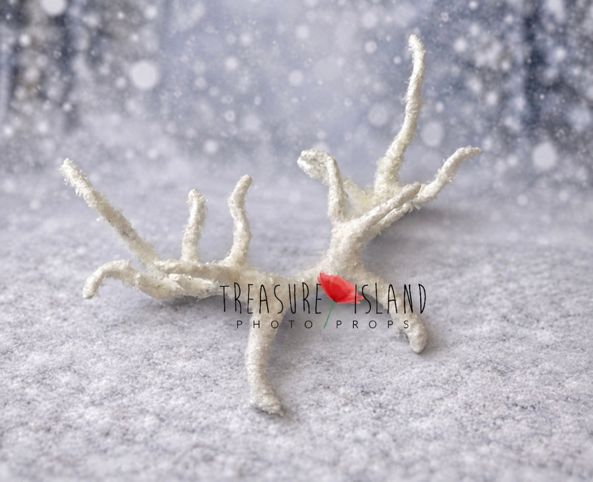 Detail of handmade reindeer antlers headband covered with textured snow-like finish
