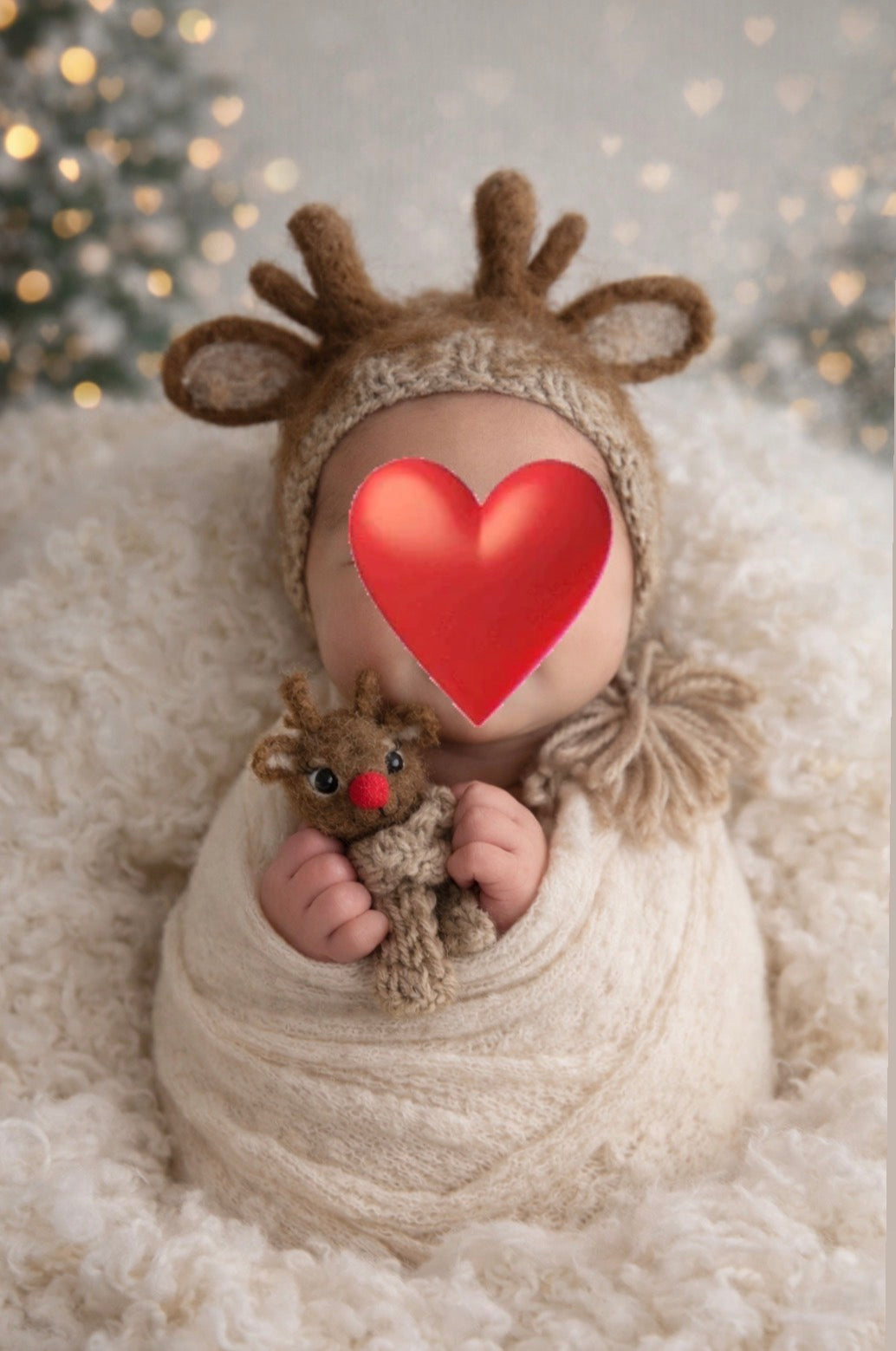Newborn styled with reindeer bonnet and matching red-nosed felted reindeer toy for Christmas photography