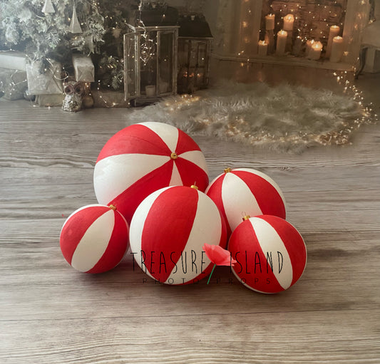 Red and white two-tone Christmas baubles in multiple sizes for festive photography setups