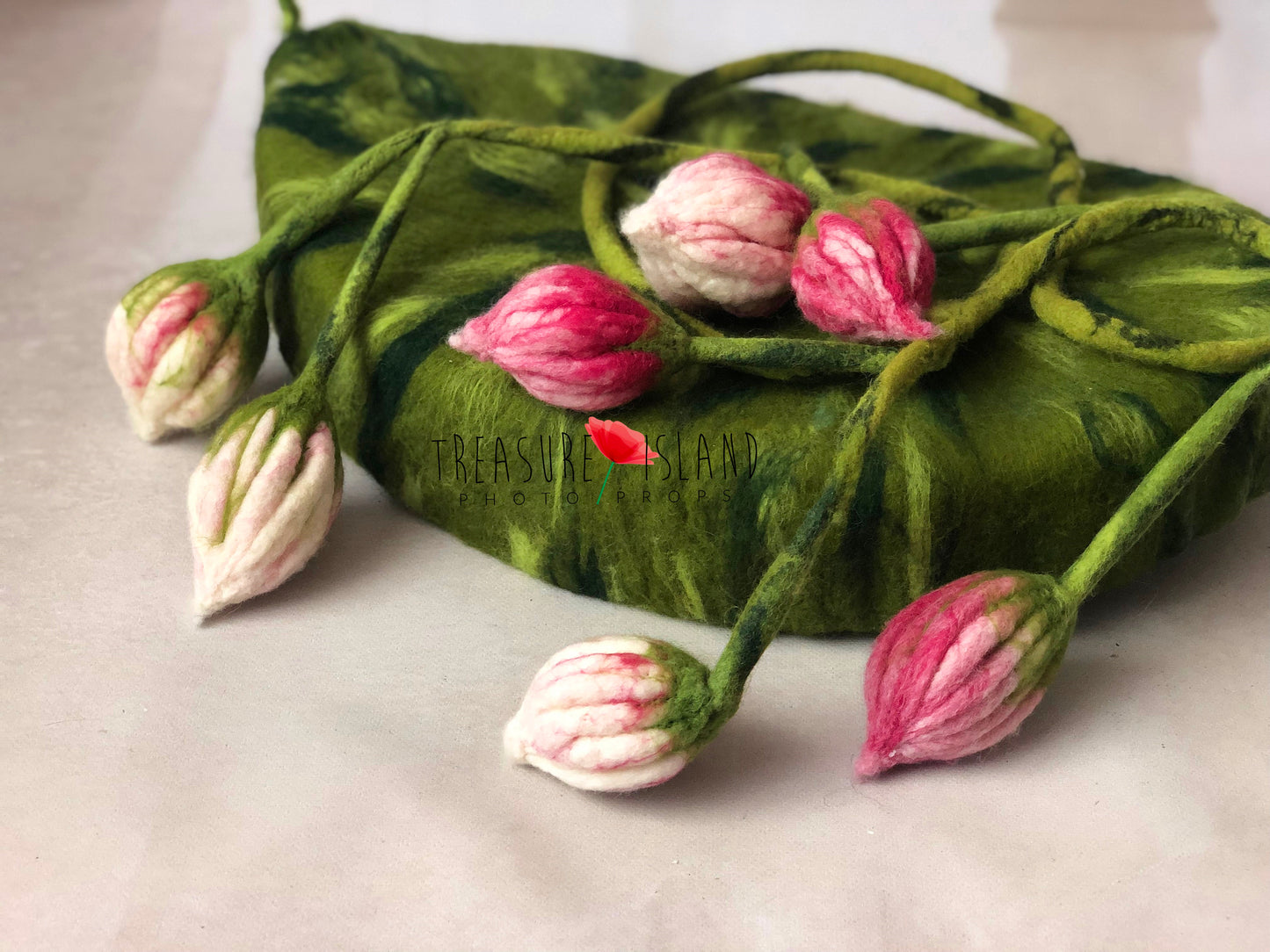 Detail of soft hand-felted newborn posing nest with botanical texture