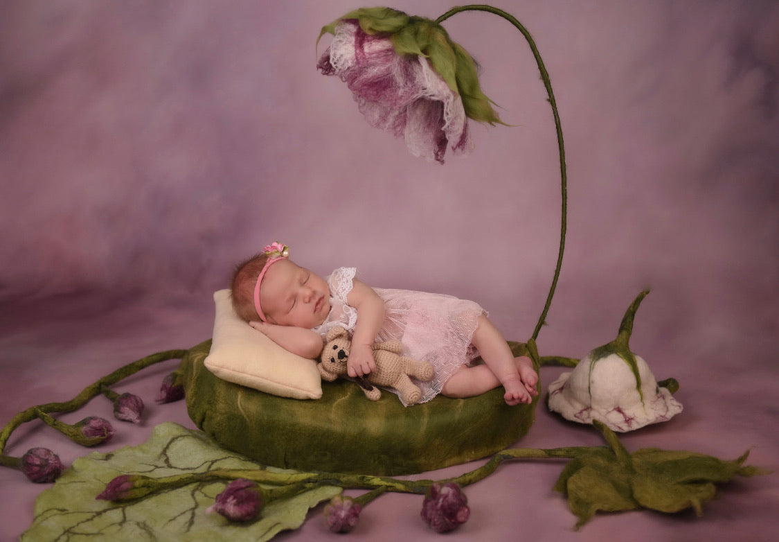 Handmade floral newborn posing prop styled with curved flower stem and buds
