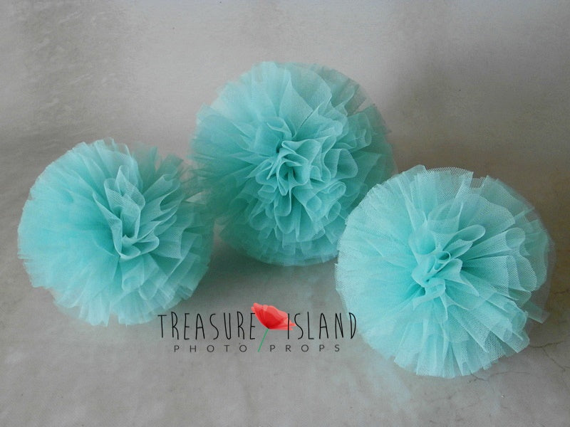 Turquoise tulle pom poms in multiple sizes for photography setups