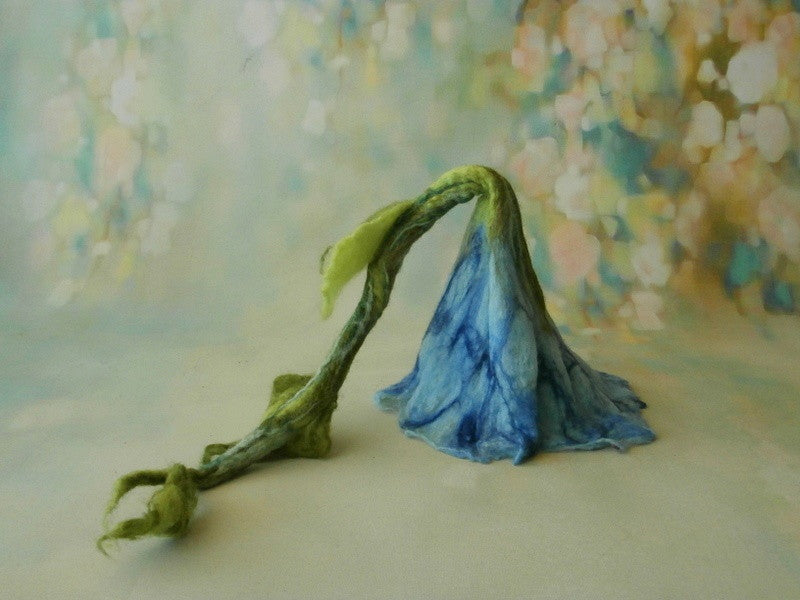 Hand-felted blue flower hat with long sculpted green stalk and leaves for newborn photography