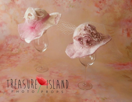 Two handmade felted floral hats with veil and pearl details for newborn and sitter photography