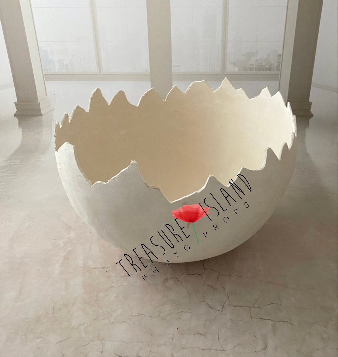 Side view of handmade plaster egg shell showing its deep rounded shape