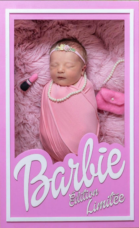 Newborn photography setup styled with miniature pink doll accessories, pearl necklace, felt handbag and lipstick