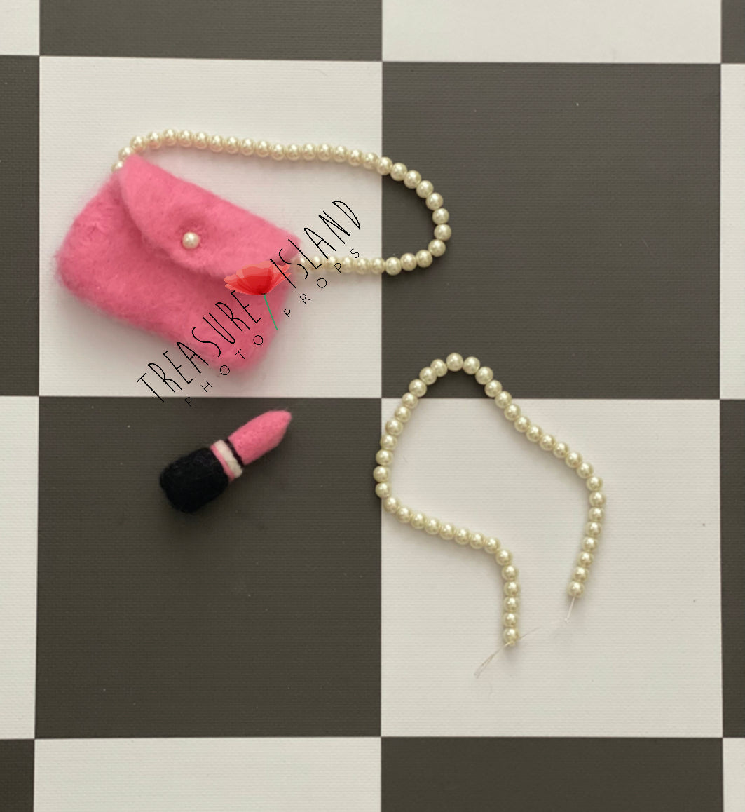 Hand-felted miniature pink handbag with pearl-style handle, pearl necklace and lipstic for newborn photography styling
