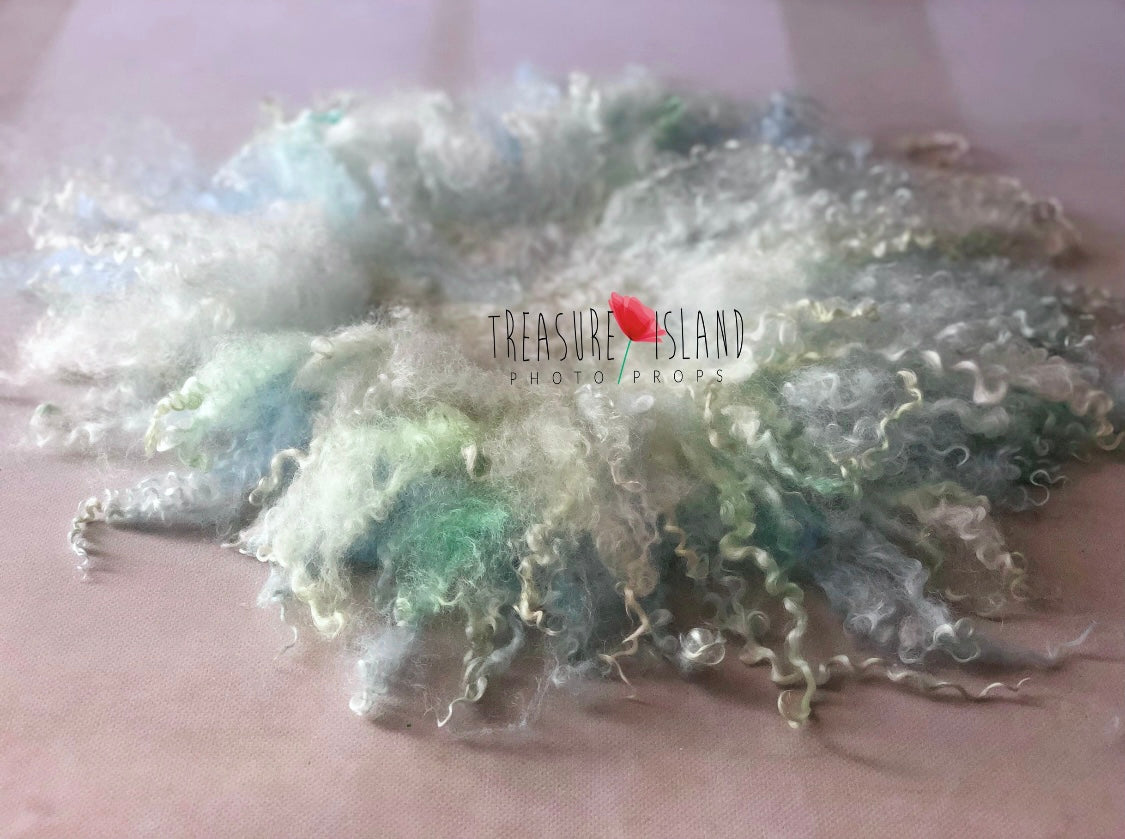 Close view of natural sheep curls and hand-felted wool texture on the Sea Glass photography blanket