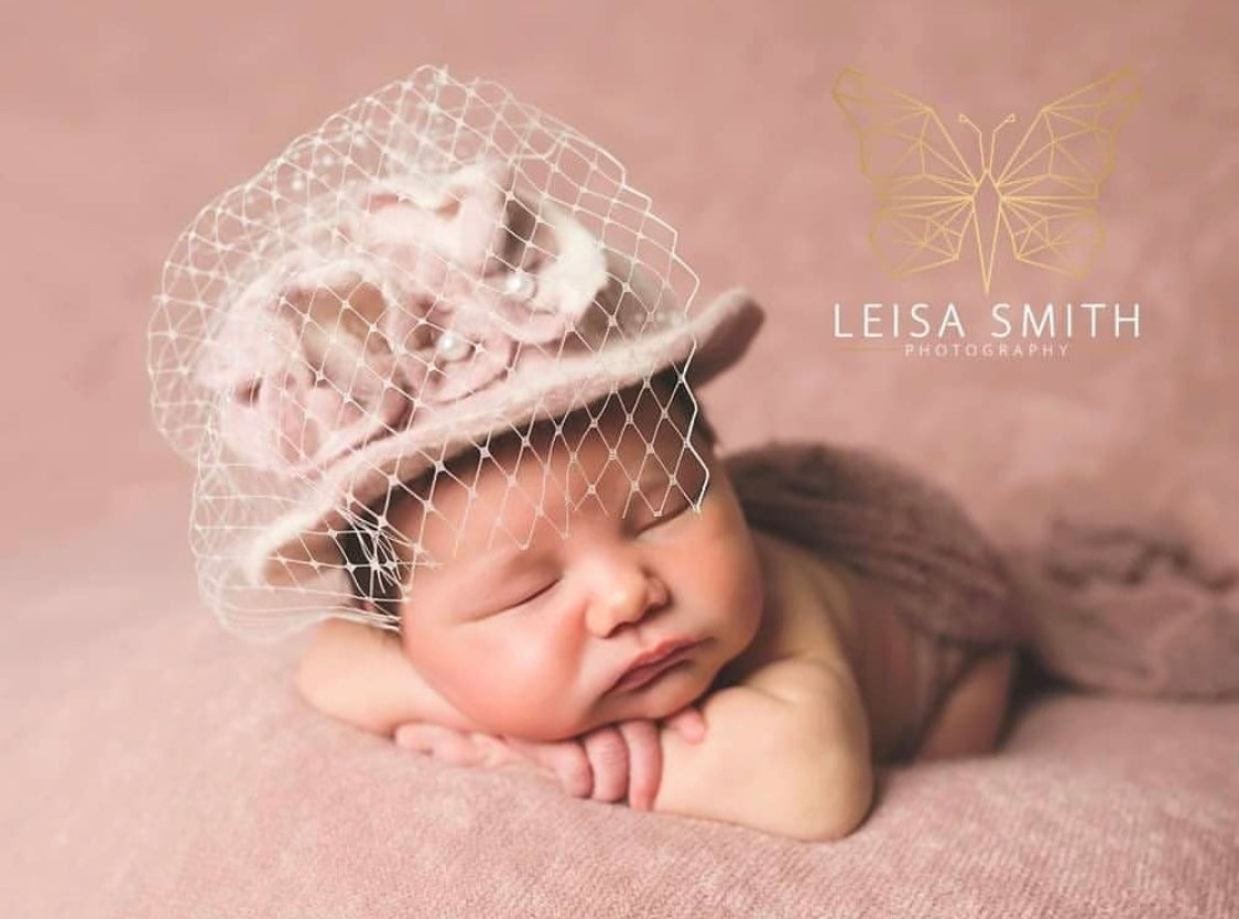 Newborn wearing Vivienne felted floral hat with veil during a Fine Art photography session